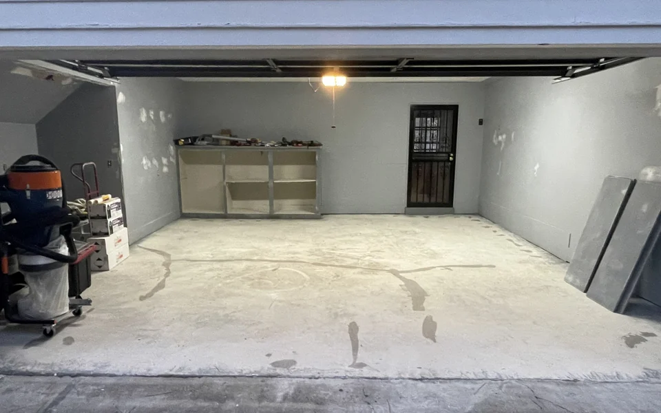 Garage concrete floor with repaired cracks before coating