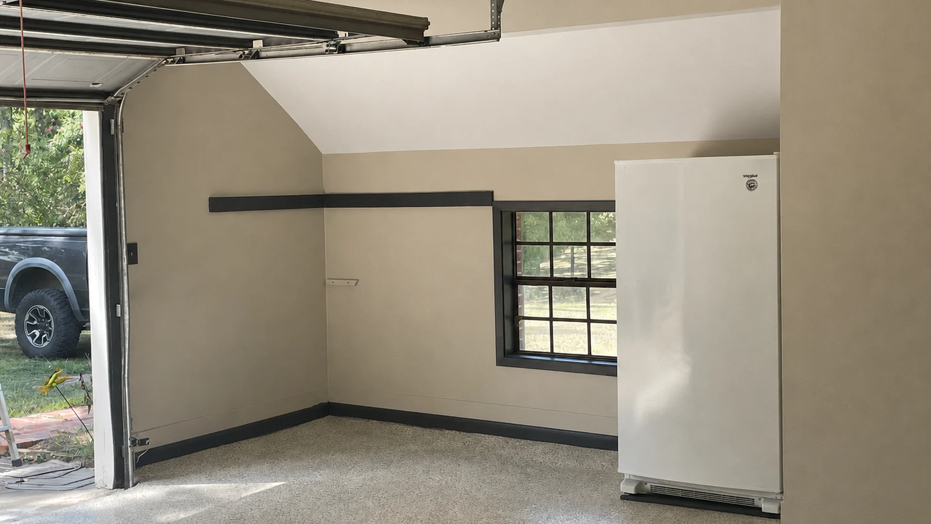 Finished garage alcove with a textured floor