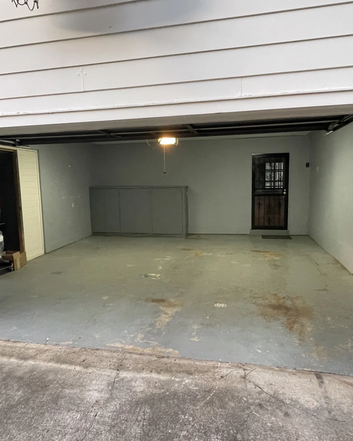 Worn coating and discolored patches on an existing garage floor