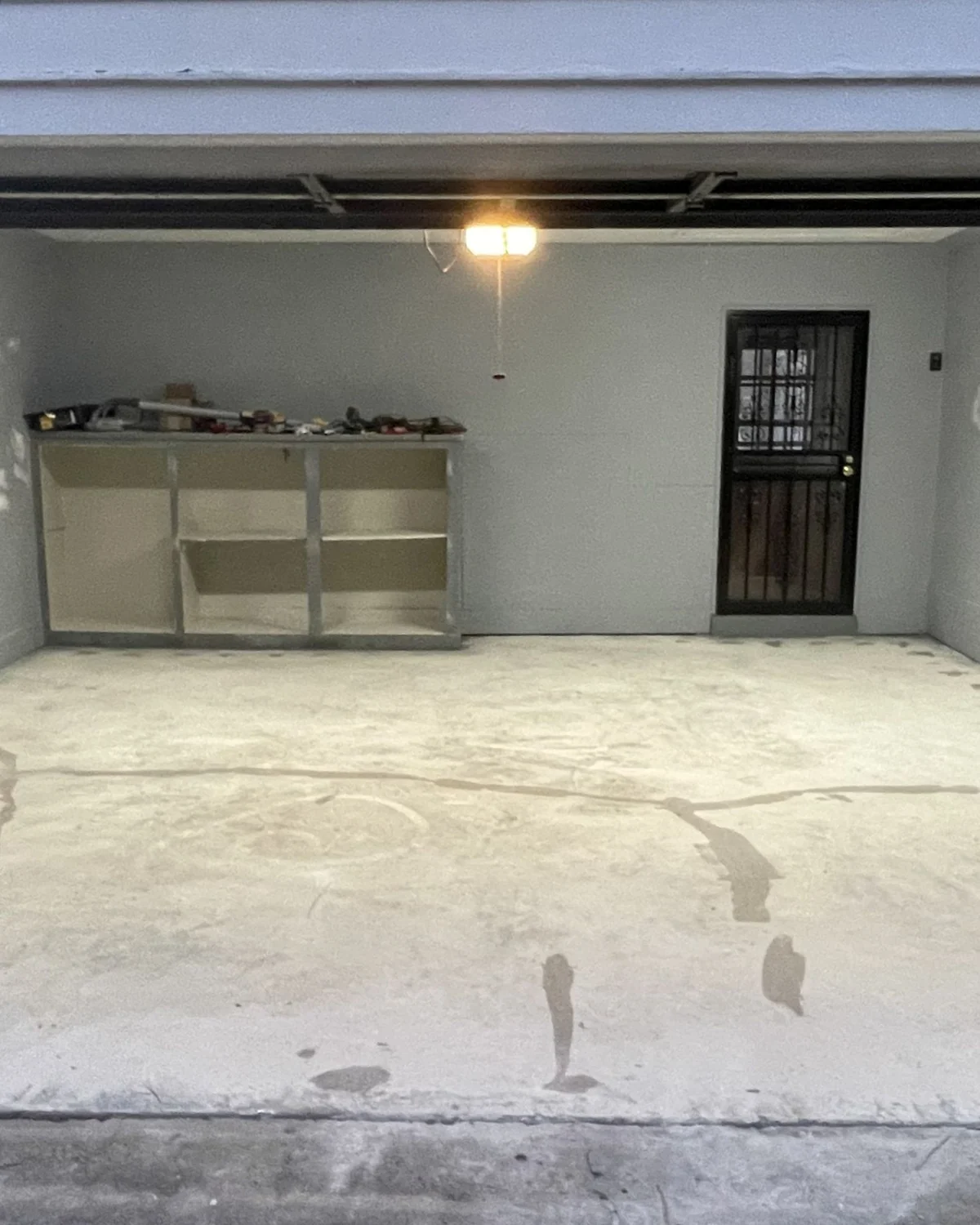 Patched concrete slab inside a garage awaiting its finish